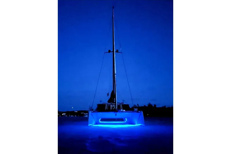 Crux Yacht Photos Pics 2017 Harvey Yachts 58 illuminated with blue lights at night.