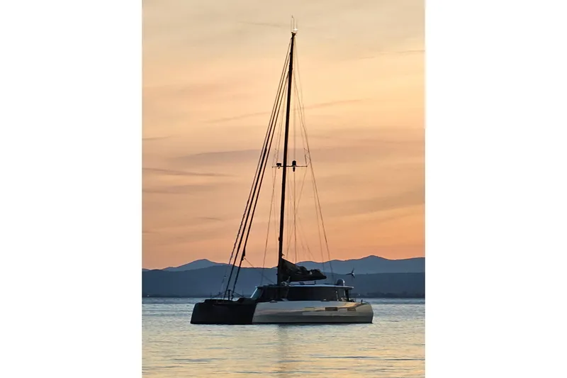 Crux Yacht Photos Pics Sailing yacht Harvey Yachts 58, 2017 model, at sunset on calm waters.