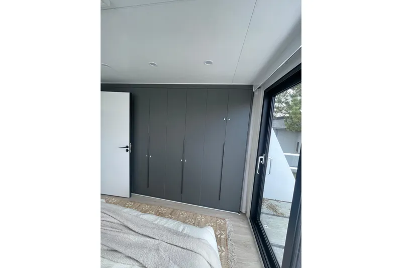  Yacht Photos Pics Modern interior of 2025 Houseboat ALLHOUSE HB-1250 with sleek design and large window.