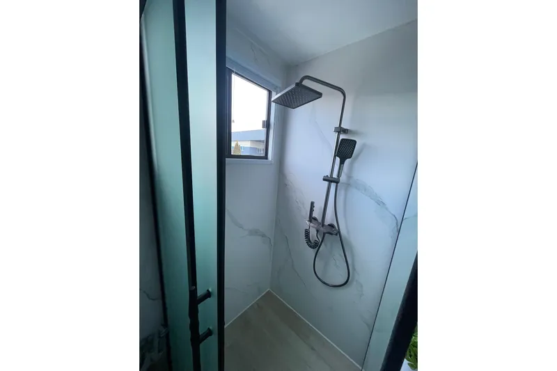  Yacht Photos Pics Modern shower in 2025 ALLHOUSE HB-1250 houseboat, featuring sleek design and frosted glass door.