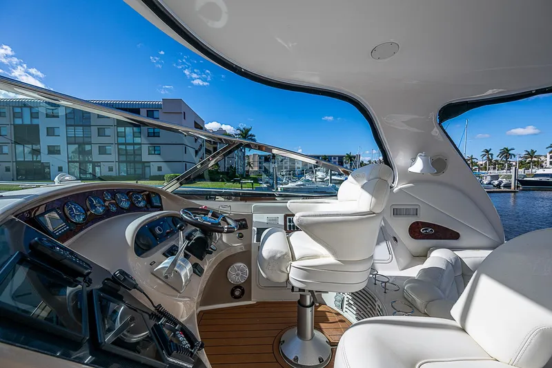 Nauti Buoy Yacht Photos Pics Luxurious 2002 Sea Ray 510 Sundancer yacht cockpit with modern controls and plush seating.