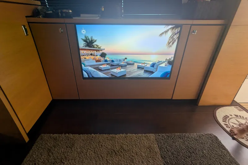  Yacht Photos Pics Interior of 2009 Fairline Squadron 55 yacht with a screen displaying a tropical beach scene.