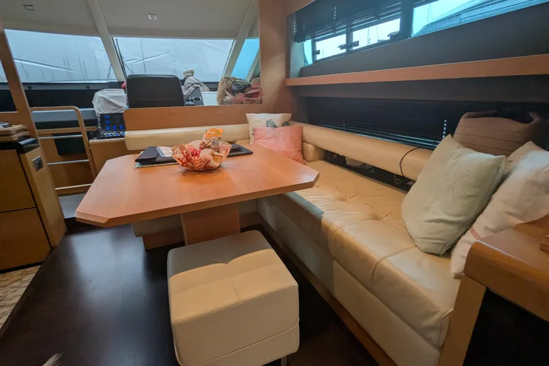  Yacht Photos Pics Luxurious interior of 2009 Fairline Squadron 55 yacht with cozy seating and dining area.