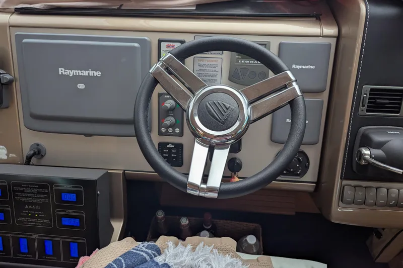  Yacht Photos Pics Steering wheel and dashboard of 2009 Fairline Squadron 55 yacht with Raymarine equipment.