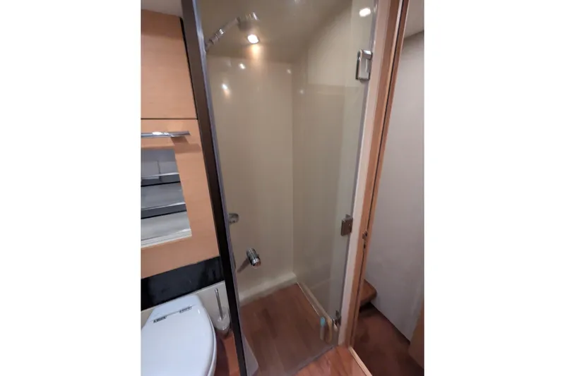  Yacht Photos Pics Bathroom interior of 2009 Fairline Squadron 55 yacht, featuring shower and toilet.