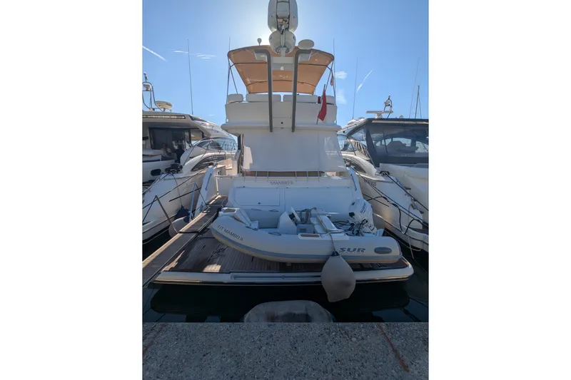  Yacht Photos Pics 2009 Fairline Squadron 55 yacht docked with inflatable boat on deck.