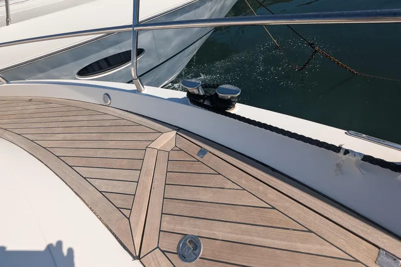  Yacht Photos Pics 2009 Fairline Squadron 55 yacht deck with wooden finish and metal railing.