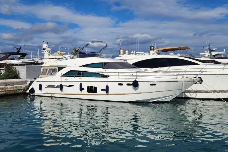  Yacht Photos Pics 2009 Fairline Squadron 55 yacht docked in a marina under a partly cloudy sky.