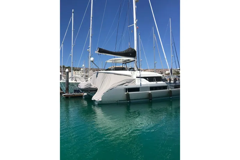  Yacht Photos Pics 2020 Lagoon 50 catamaran docked in a marina with clear blue water.