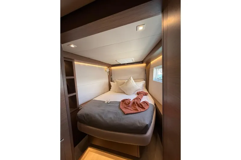  Yacht Photos Pics Luxurious cabin interior of 2020 Lagoon 50 yacht with cozy bed and modern design.