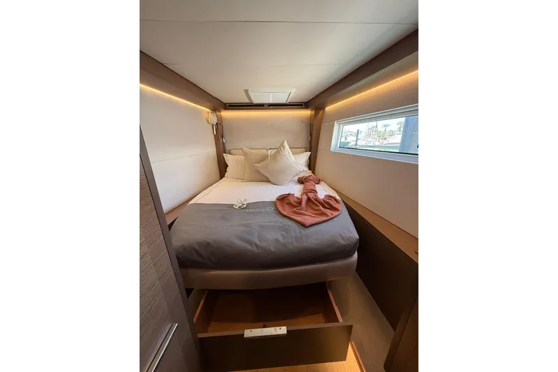  Yacht Photos Pics Luxurious cabin interior of 2020 Lagoon 50 yacht with cozy bed and modern design.