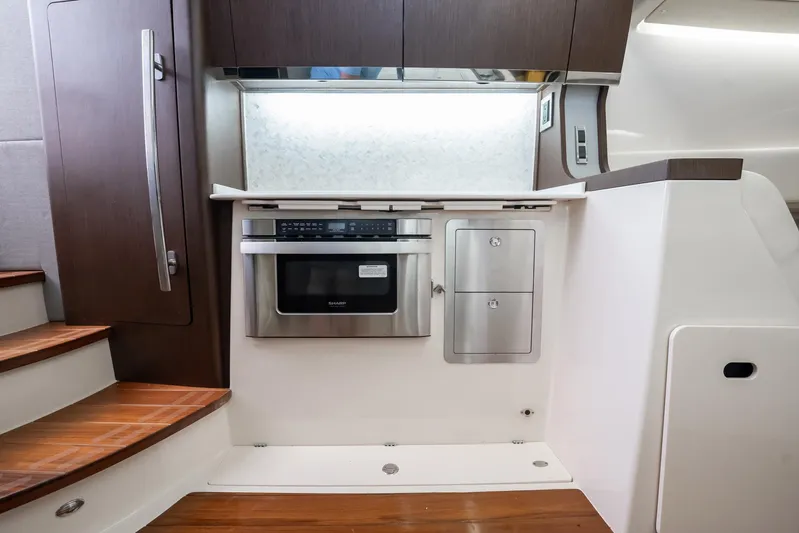 4 Reels Yacht Photos Pics 2021 Grady-White Canyon 456 interior with modern kitchen appliances and sleek cabinetry.