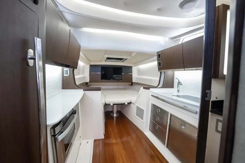 4 Reels Yacht Photos Pics Luxurious interior of 2021 Grady-White Canyon 456 boat with modern kitchen and seating area.