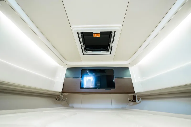4 Reels Yacht Photos Pics Interior cabin of 2021 Grady-White Canyon 456 with TV and ceiling hatch.