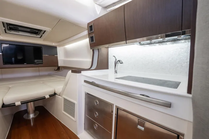 4 Reels Yacht Photos Pics 2021 Grady-White Canyon 456 interior with kitchenette and seating area.