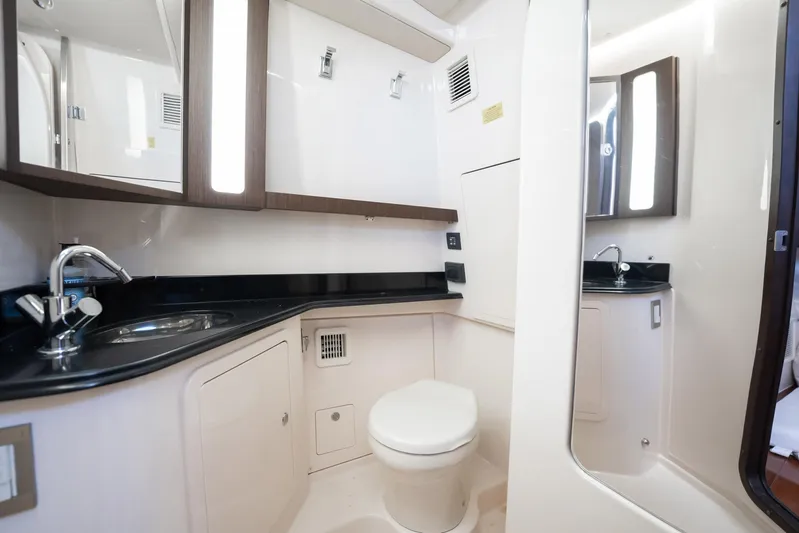 4 Reels Yacht Photos Pics 2021 Grady-White Canyon 456 boat bathroom with modern fixtures and sleek design.