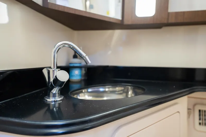 4 Reels Yacht Photos Pics 2021 Grady-White Canyon 456 boat interior with sleek sink and faucet.