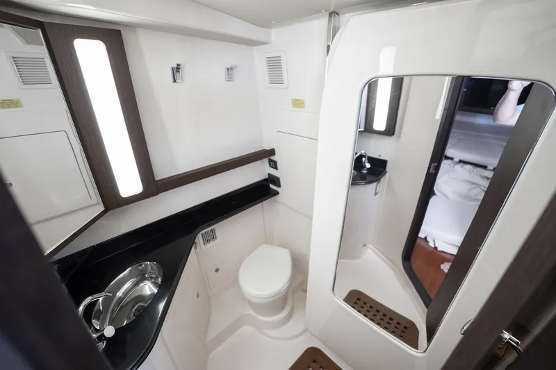 4 Reels Yacht Photos Pics Luxurious bathroom interior of 2021 Grady-White Canyon 456 boat, featuring modern fixtures.