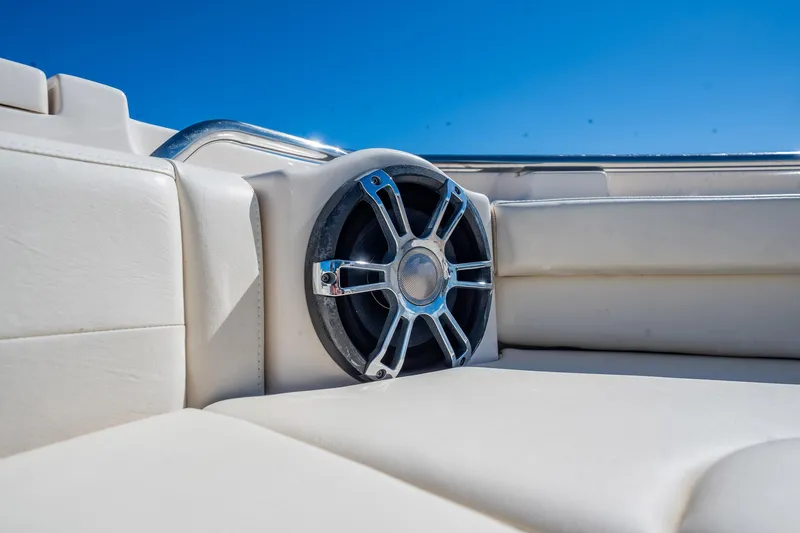 4 Reels Yacht Photos Pics Speaker on 2021 Grady-White Canyon 456 boat, featuring white leather seating.
