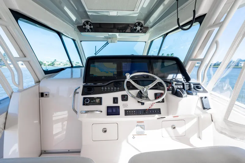 4 Reels Yacht Photos Pics 2021 Grady-White Canyon 456 boat helm with advanced navigation system.