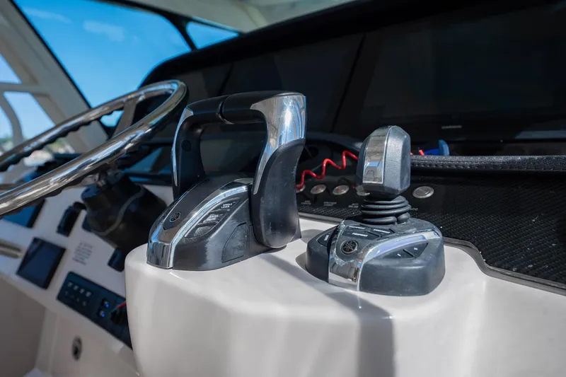 4 Reels Yacht Photos Pics Control panel of 2021 Grady-White Canyon 456 boat with steering wheel and throttle.