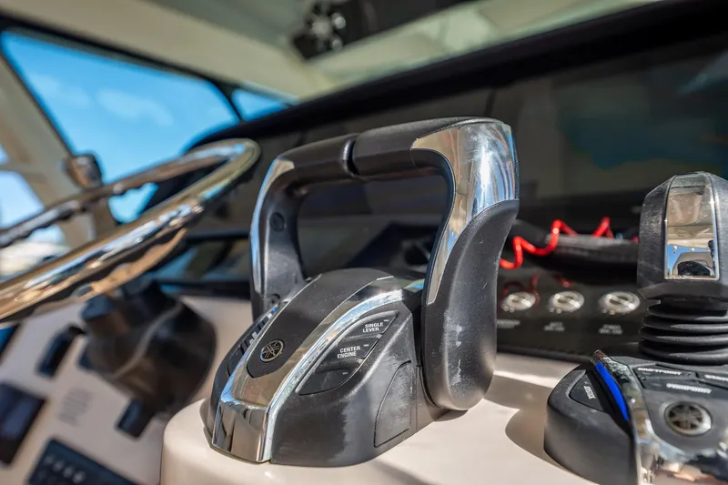 4 Reels Yacht Photos Pics Close-up of 2021 Grady-White Canyon 456 boat controls and steering wheel.