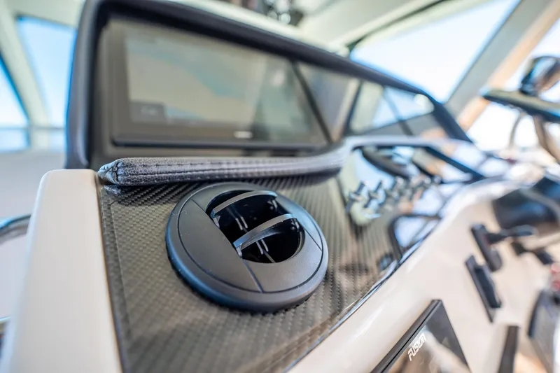 4 Reels Yacht Photos Pics 2021 Grady-White Canyon 456 dashboard with carbon fiber accents and control panel.