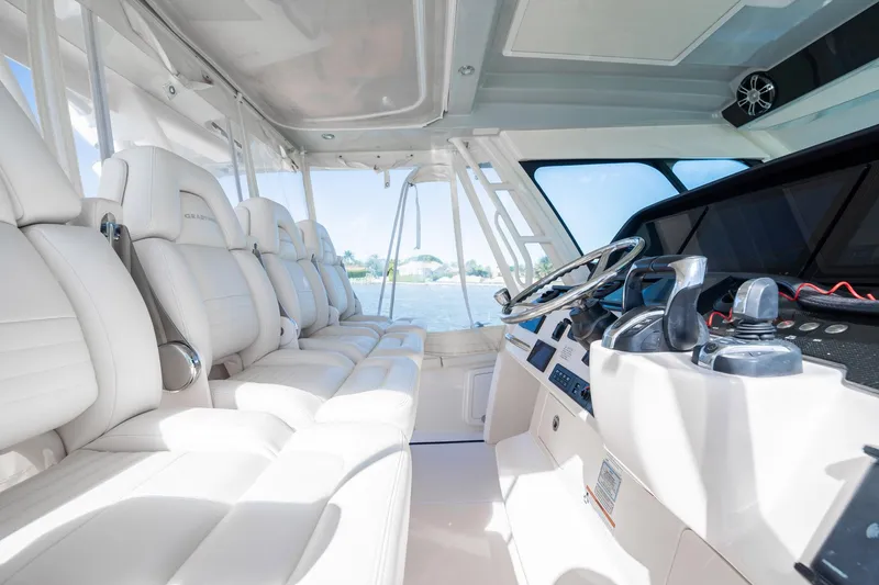 4 Reels Yacht Photos Pics Interior of 2021 Grady-White Canyon 456 boat with luxurious seating and modern controls.