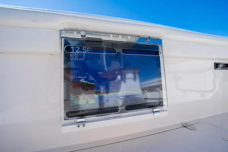 4 Reels Yacht Photos Pics 2021 Grady-White Canyon 456 boat with Garmin display, showing depth and sonar data.