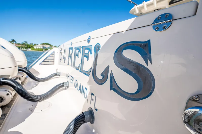 4 Reels Yacht Photos Pics 2021 Grady-White Canyon 456 boat with custom lettering, docked at Jupiter Island, FL.