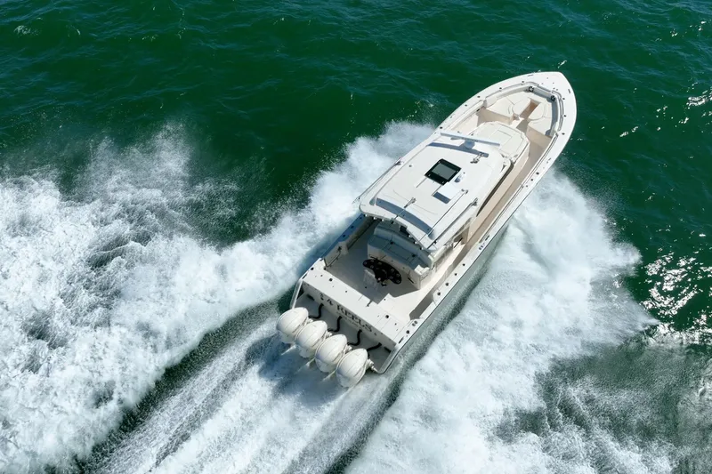 4 Reels Yacht Photos Pics 2021 Grady-White Canyon 456 boat cruising on open water, aerial view.