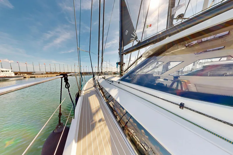  Yacht Photos Pics 2024 Amel 60 yacht docked in a marina, showcasing sleek design and modern features.