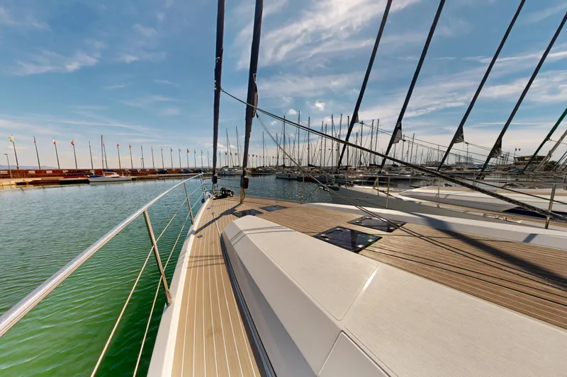  Yacht Photos Pics 2024 Amel 60 yacht deck with marina view under clear blue sky.
