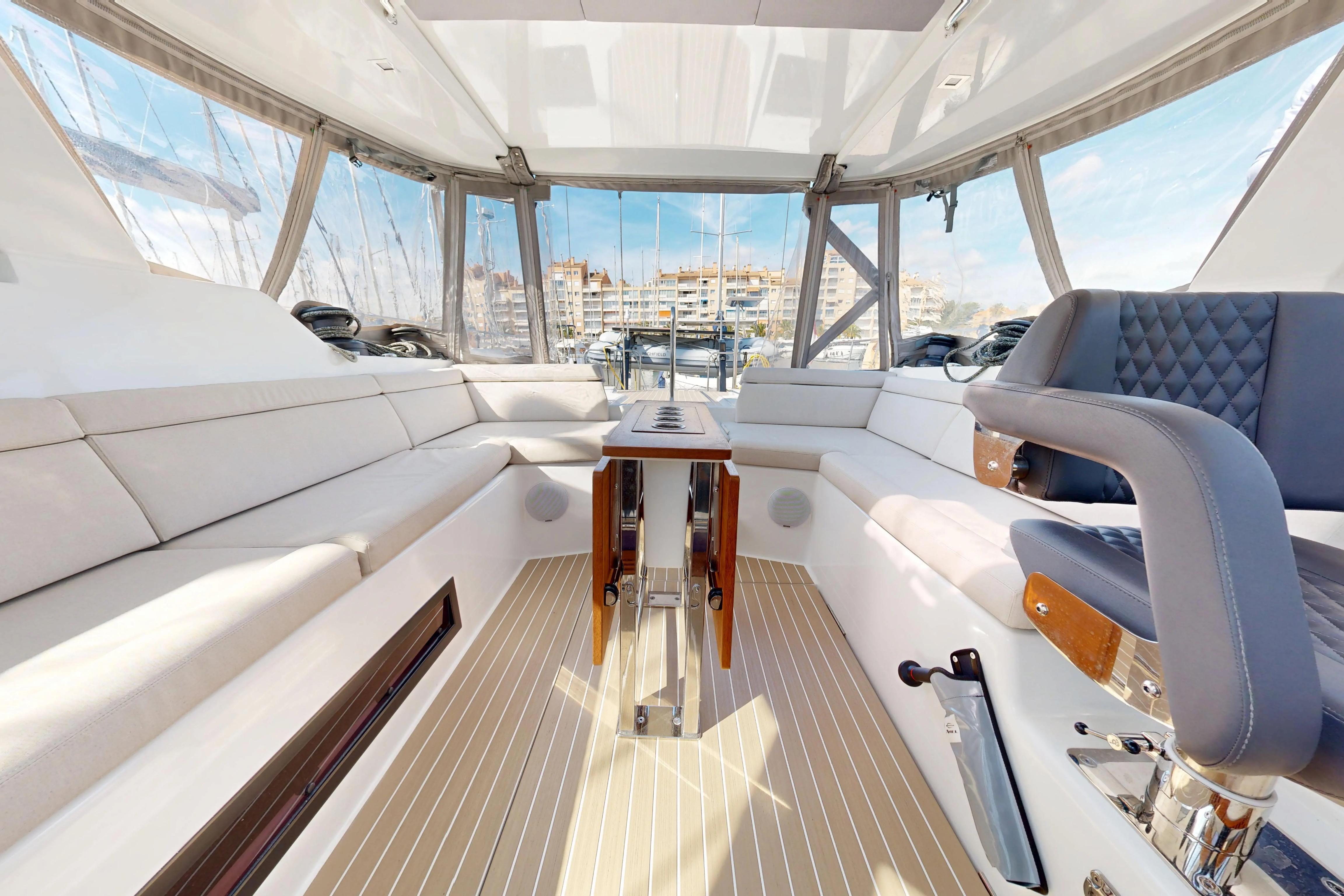 Luxurious interior of 2024 Amel 60 yacht with elegant seating and panoramic windows.