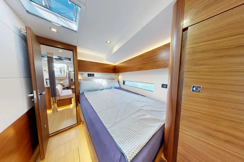  Yacht Photos Pics Luxurious cabin interior of 2024 Amel 60 yacht with wooden finishes and skylight.