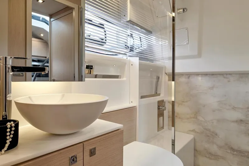  Yacht Photos Pics Luxurious bathroom interior of 2025 Jeanneau DB/43 IB yacht with modern fixtures.