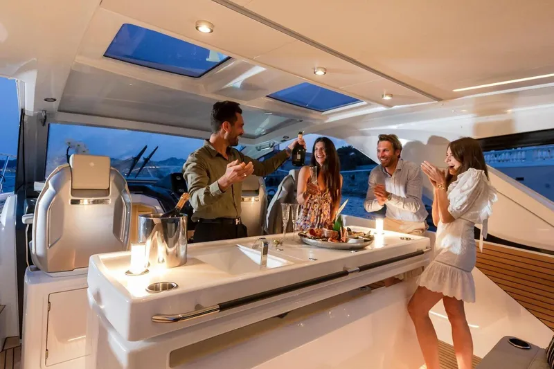  Yacht Photos Pics People enjoying a celebration on a 2025 Jeanneau DB/43 IB yacht at sunset.