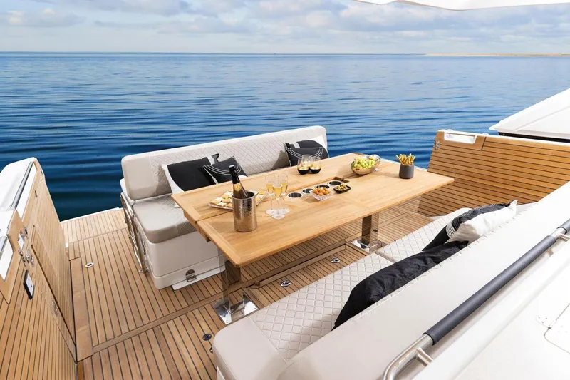  Yacht Photos Pics 2025 Jeanneau DB/43 IB yacht deck with elegant dining setup and ocean view.