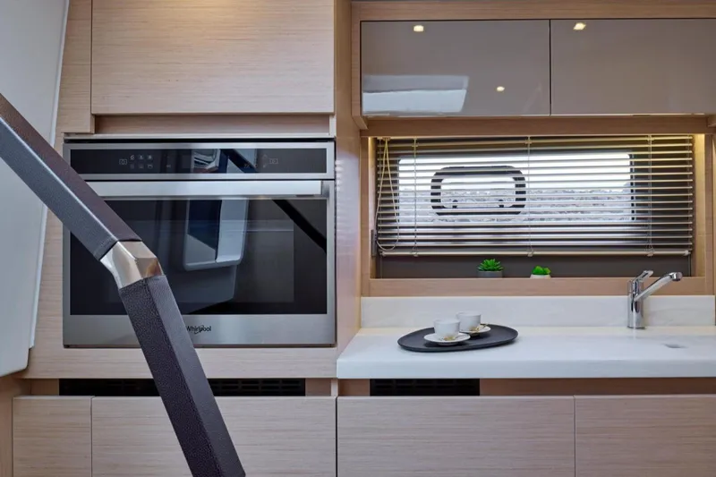  Yacht Photos Pics Modern kitchen interior of 2025 Jeanneau DB/43 IB yacht with sleek appliances.