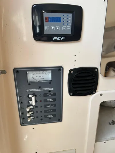  Yacht Photos Pics Control panel of a 2002 Grady-White 306 Bimini boat, featuring switches and a digital display.