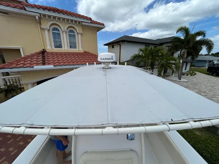  Yacht Photos Pics 2002 Grady-White 306 Bimini boat with Garmin equipment, docked near residential homes.