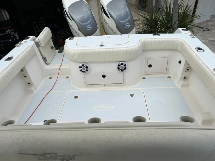  Yacht Photos Pics 2002 Grady-White 306 Bimini boat deck with seating and storage compartments.