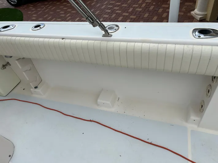  Yacht Photos Pics 2002 Grady-White 306 Bimini boat interior with rod holders and cushioned seating.