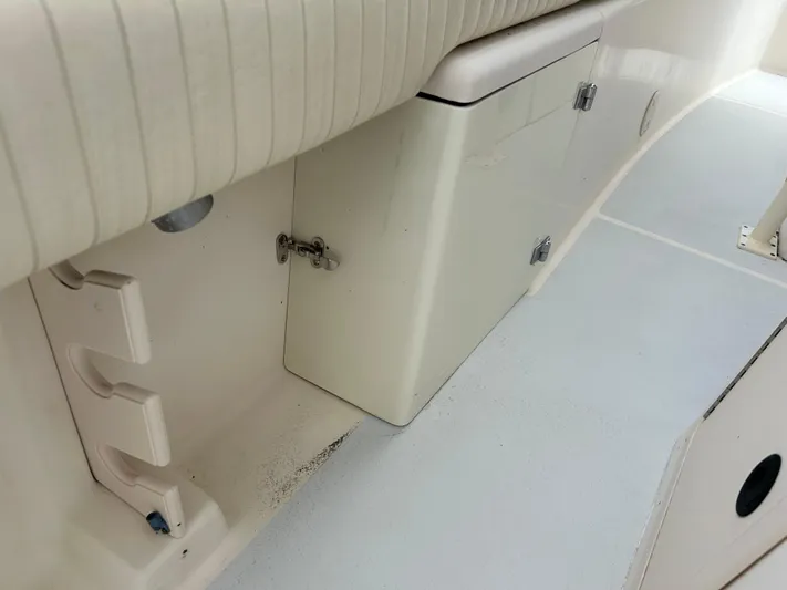  Yacht Photos Pics 2002 Grady-White 306 Bimini boat interior, featuring storage compartment and seating area.