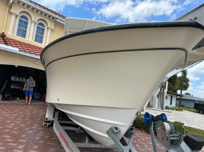  Yacht Photos Pics 2002 Grady-White 306 Bimini boat on trailer, parked in driveway.