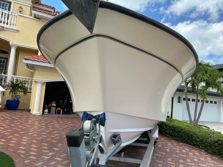  Yacht Photos Pics 2002 Grady-White 306 Bimini boat on trailer in residential driveway.