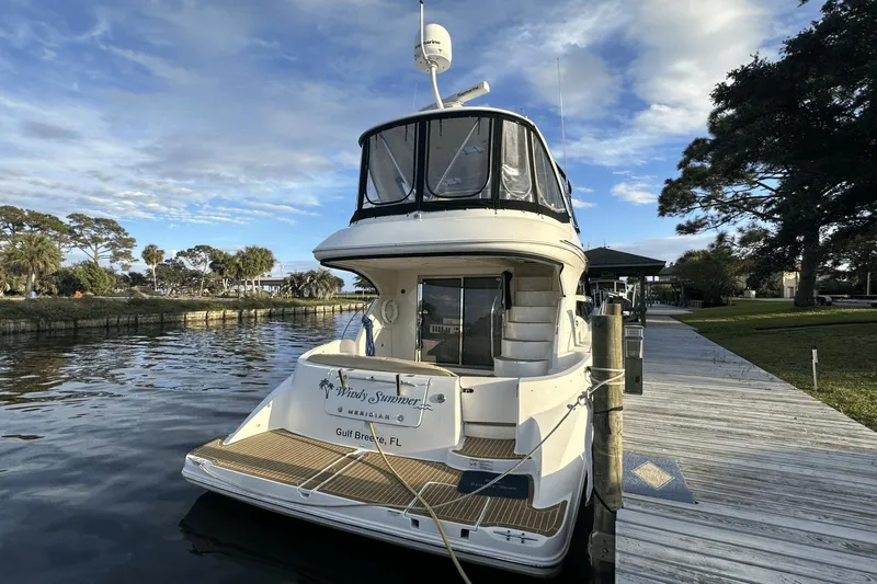  Yacht Photos Pics 2015 Meridian 441 Sedan yacht docked by a scenic waterfront.