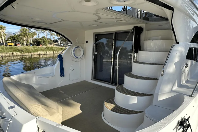  Yacht Photos Pics 2015 Meridian 441 Sedan yacht interior with curved stairs and seating area.