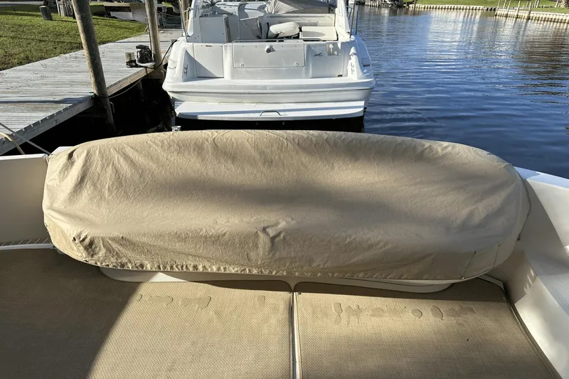 Yacht Photos Pics Covered seating area on a 2015 Meridian 441 Sedan yacht at a dock.
