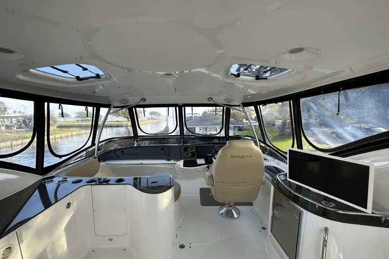  Yacht Photos Pics Interior of 2015 Meridian 441 Sedan yacht with panoramic windows and modern helm.